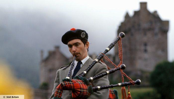 Man with bagpipes, Eilean Donan Castle, Highlands,© Visit Britain